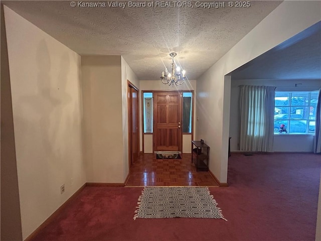 4915 Chesterfield Ave, Charleston, WV 25304 - entryway with baseboards, carpet flooring, a chandelier, and a textured ceiling