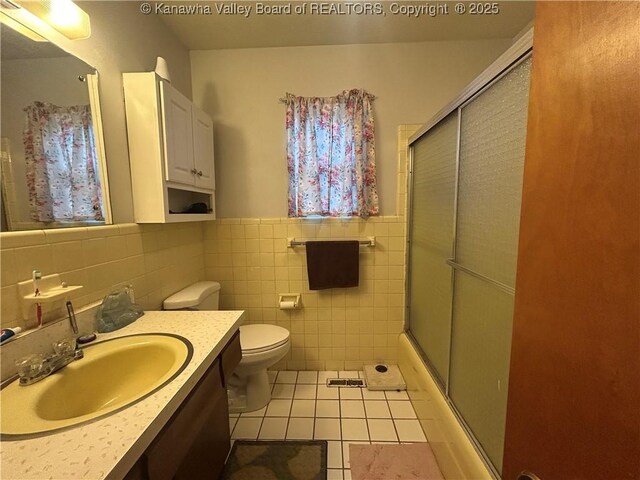4915 Chesterfield Ave, Charleston, WV 25304 - full bath featuring tile patterned floors, vanity, tile walls, toilet, and an enclosed shower