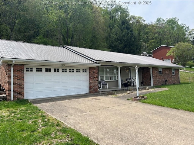 4915 Chesterfield Ave, Charleston, WV 25304 - single story home featuring a front lawn, concrete driveway, covered porch, a garage, and brick siding