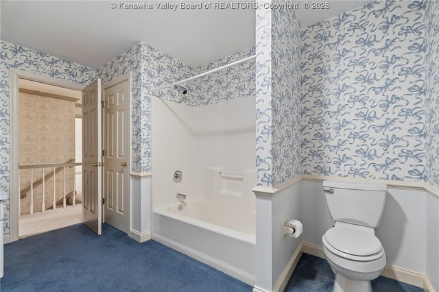 bathroom with toilet, wallpapered walls, baseboards, and shower / bathtub combination