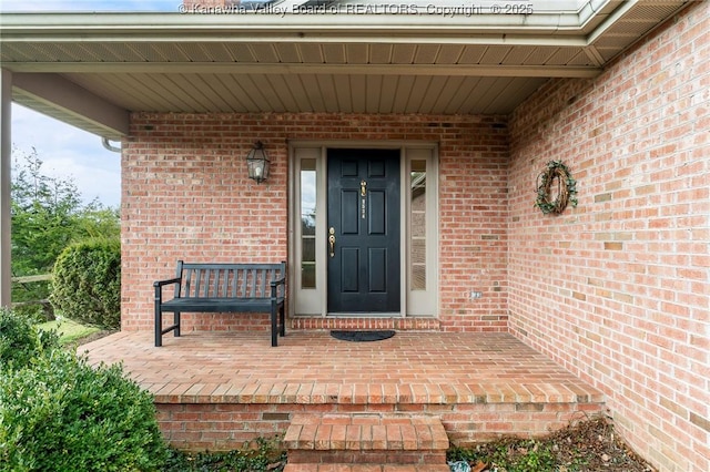 entrance to property featuring brick siding