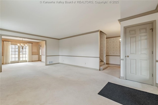 empty room with light carpet, visible vents, stairway, wallpapered walls, and crown molding