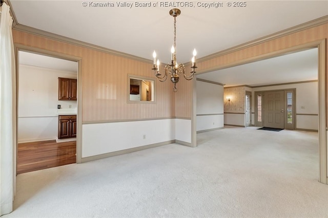 spare room with baseboards, ornamental molding, and light colored carpet