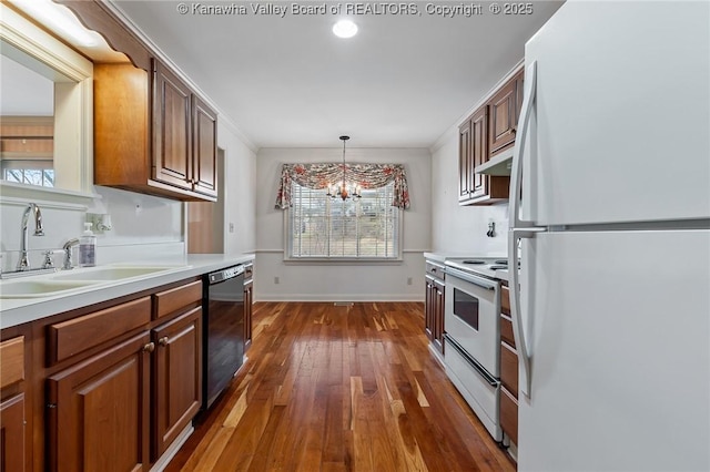 kitchen with dark wood-style flooring, light countertops, a sink, white appliances, and under cabinet range hood