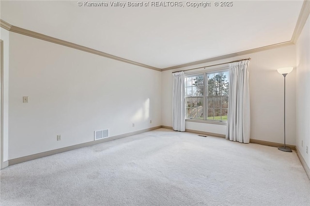 spare room with crown molding, baseboards, visible vents, and light colored carpet