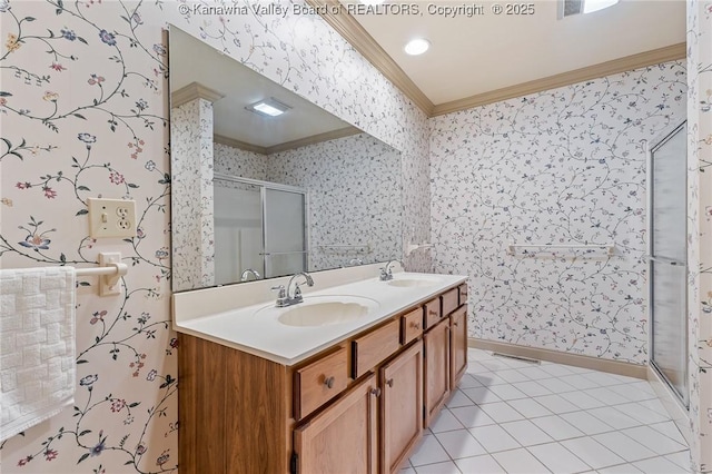 full bath with a sink, wallpapered walls, crown molding, and a stall shower