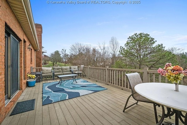 wooden deck with visible vents and outdoor lounge area