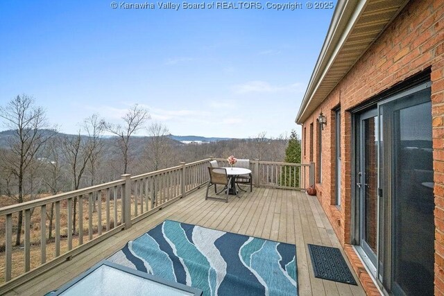 deck featuring outdoor dining area