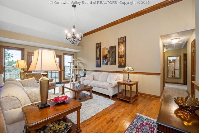 living area with a healthy amount of sunlight, light wood-style floors, baseboards, and crown molding