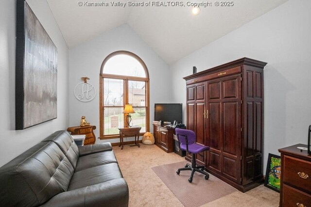 office area featuring light carpet and vaulted ceiling