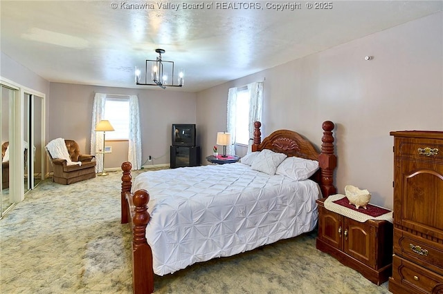 bedroom with a notable chandelier and carpet flooring