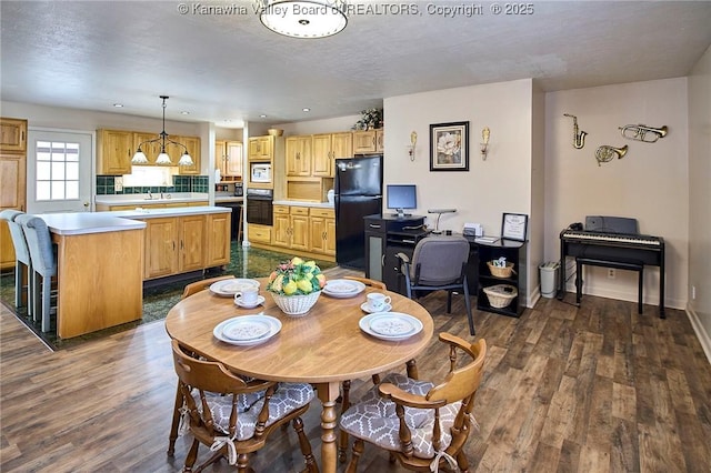 dining space with dark wood-type flooring, recessed lighting, a textured ceiling, and baseboards