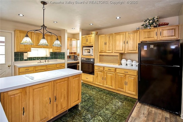 kitchen featuring hanging light fixtures, black appliances, light countertops, and backsplash