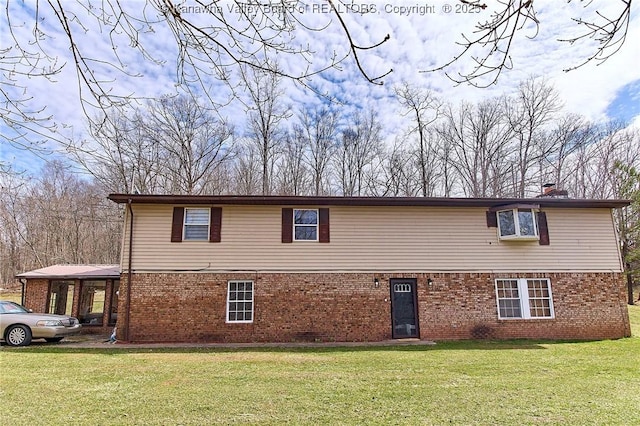 view of side of home with a yard, brick siding, and a chimney