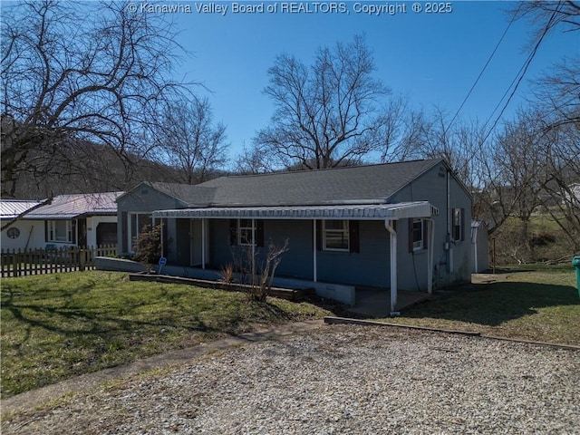 view of front of property featuring a porch, a front yard, fence, and a shingled roof