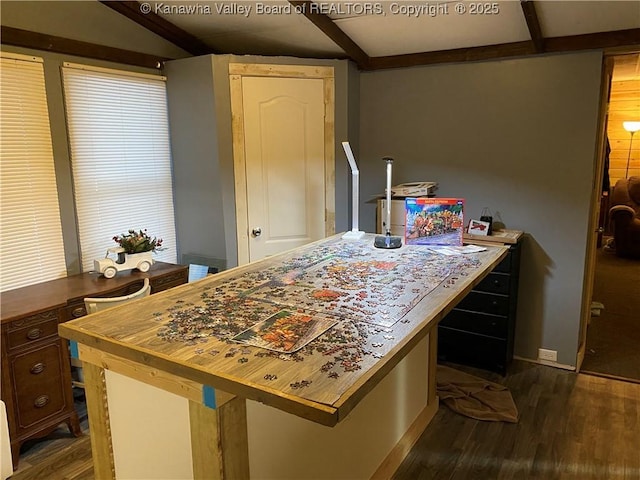 kitchen featuring dark wood-style floors and beam ceiling