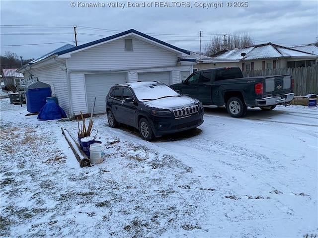 exterior space featuring a garage and fence