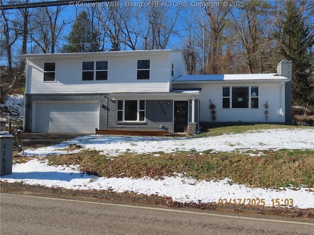 view of front of home with brick siding and an attached garage