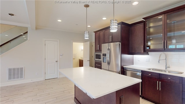 kitchen featuring light countertops, appliances with stainless steel finishes, a sink, and visible vents