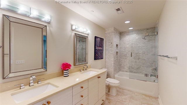 full bathroom with visible vents, a sink, toilet, and double vanity