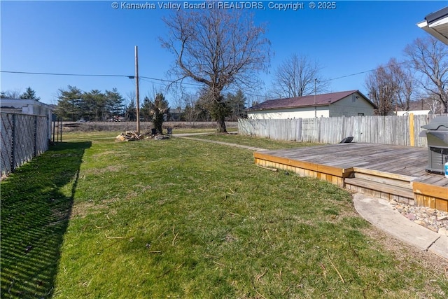 view of yard with fence and a deck