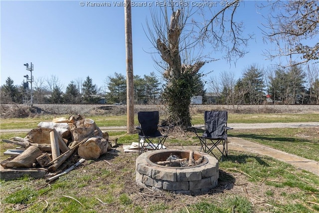 view of yard with an outdoor fire pit