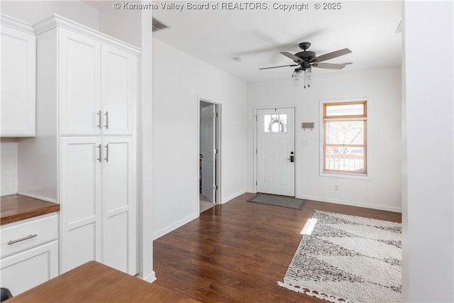 entrance foyer featuring visible vents, dark wood finished floors, baseboards, and ceiling fan