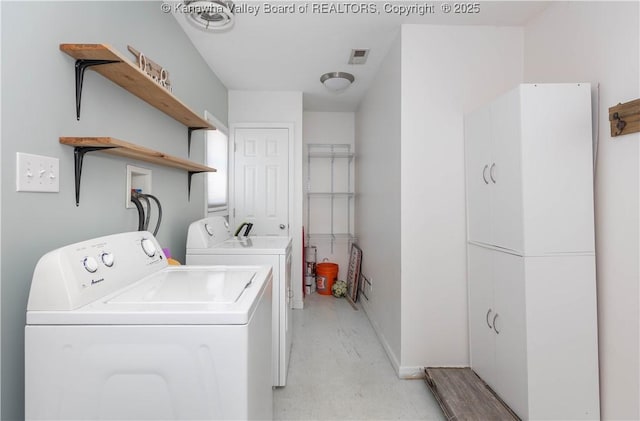 clothes washing area with laundry area, washing machine and dryer, and visible vents