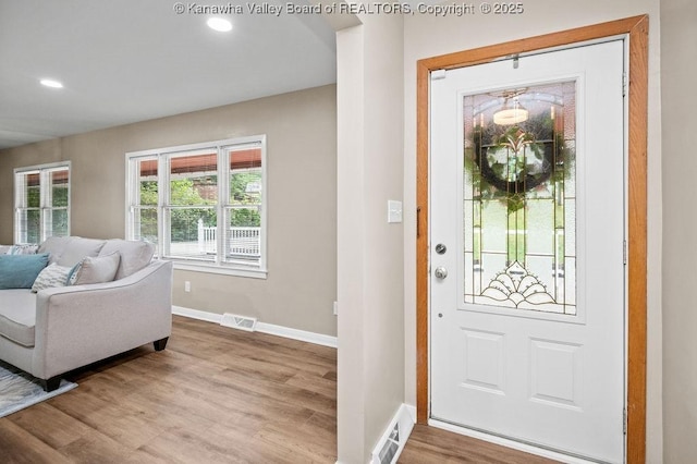 foyer entrance featuring recessed lighting, wood finished floors, visible vents, and baseboards