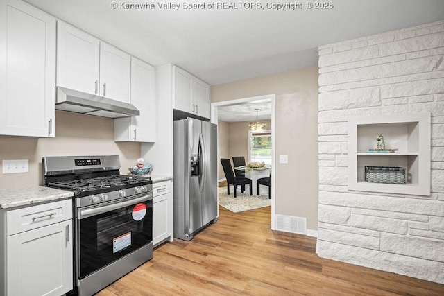 kitchen with visible vents, light wood finished floors, stainless steel appliances, white cabinets, and under cabinet range hood