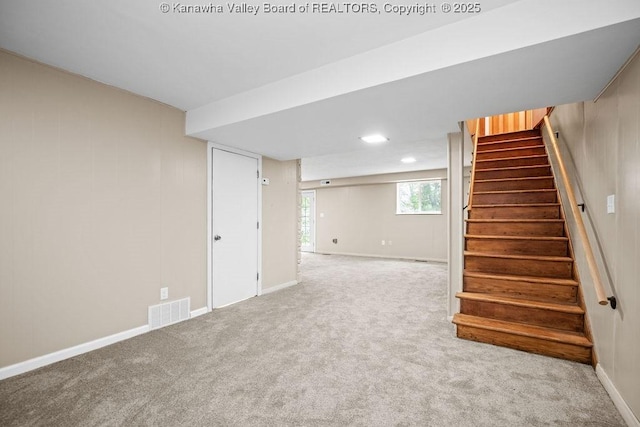 basement with stairway, baseboards, visible vents, and carpet floors