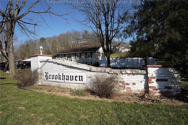 community sign featuring a lawn