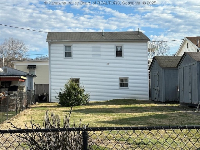 rear view of property with a yard, a storage shed, a fenced backyard, and an outdoor structure