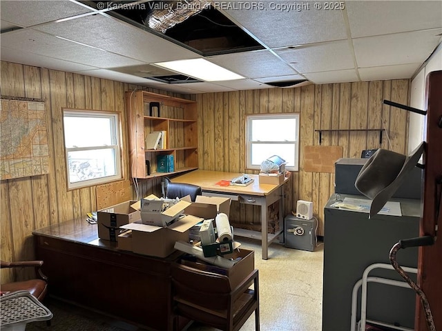 home office featuring a drop ceiling and wood walls