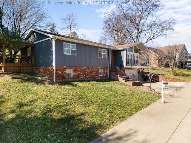 view of front facade featuring brick siding, concrete driveway, and a front yard