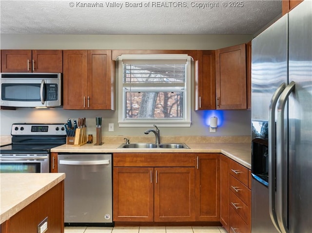 kitchen with a sink, appliances with stainless steel finishes, and light countertops