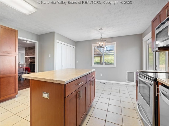 kitchen featuring light tile patterned floors, plenty of natural light, and appliances with stainless steel finishes