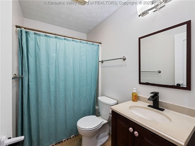 bathroom featuring vanity, a shower with shower curtain, toilet, and a textured ceiling