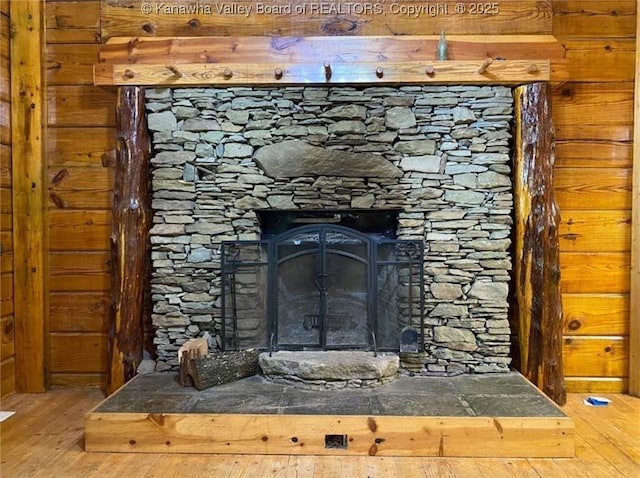 interior details featuring wood finished floors and a fireplace