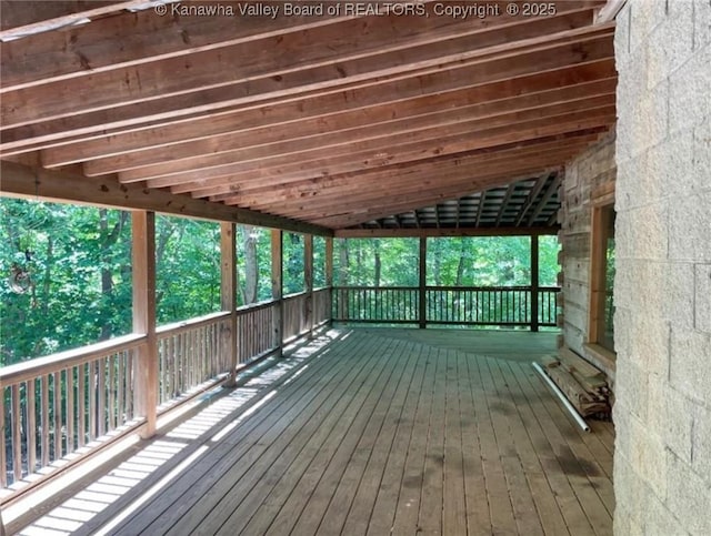 unfurnished sunroom featuring lofted ceiling