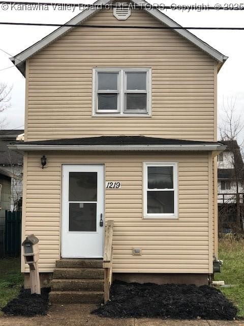 view of front of home featuring entry steps and fence