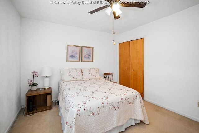 bedroom with a ceiling fan, baseboards, a closet, and light carpet