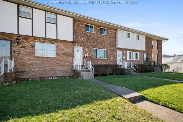 view of front of house with brick siding and a front lawn