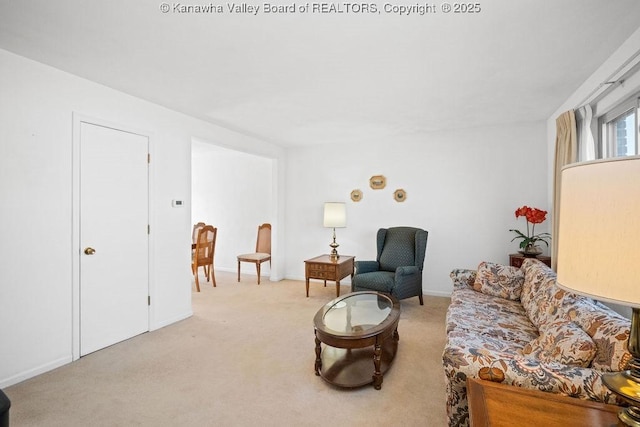 carpeted living area with baseboards