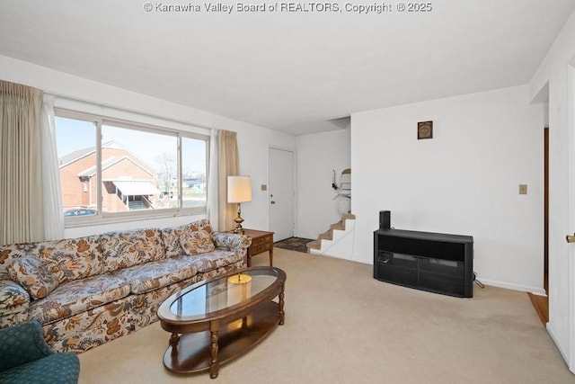 carpeted living area featuring stairway