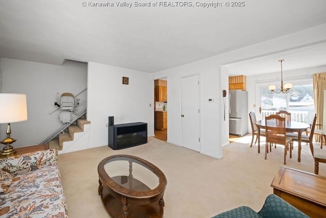 living room featuring light carpet, a chandelier, stairs, and baseboards