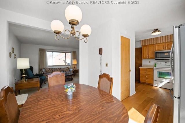 dining room with a notable chandelier and light wood finished floors