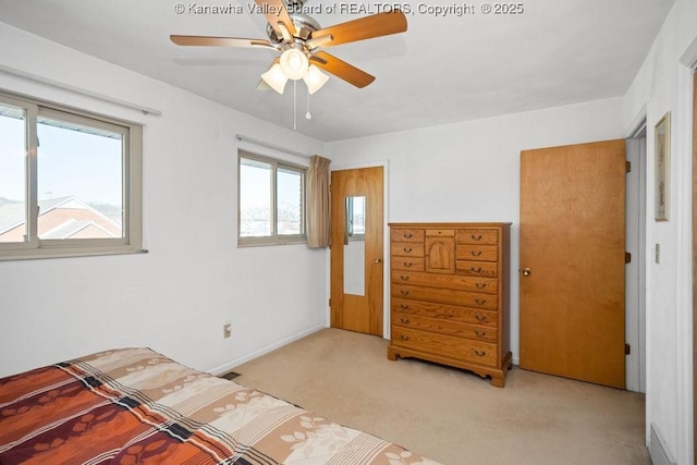 bedroom with visible vents, light carpet, and a ceiling fan