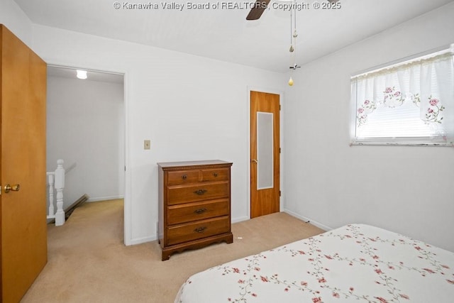 bedroom with light carpet, a ceiling fan, and baseboards