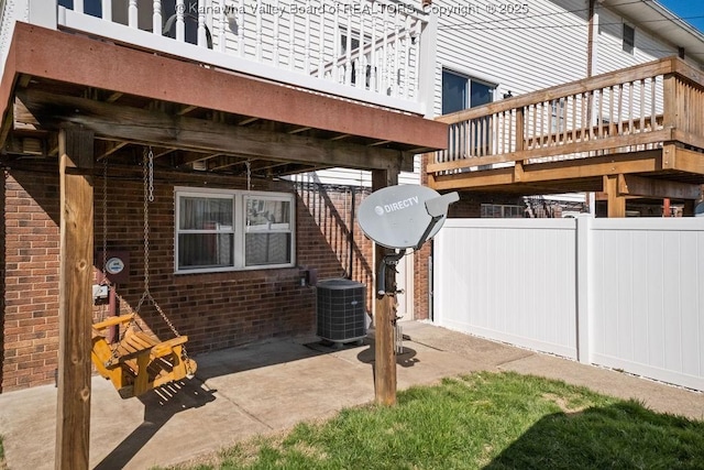 view of patio featuring cooling unit and fence